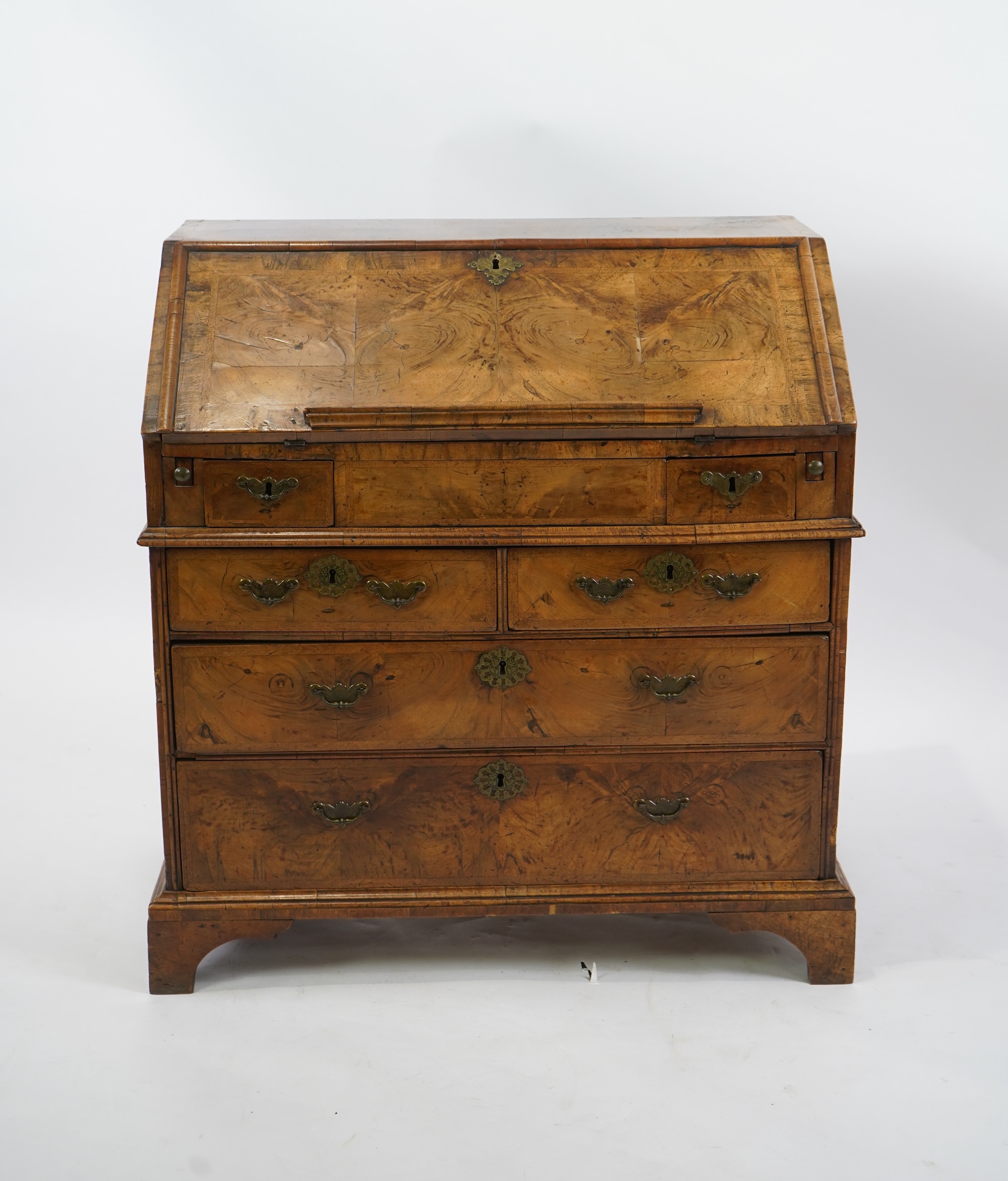 A George I feather banded walnut bureau